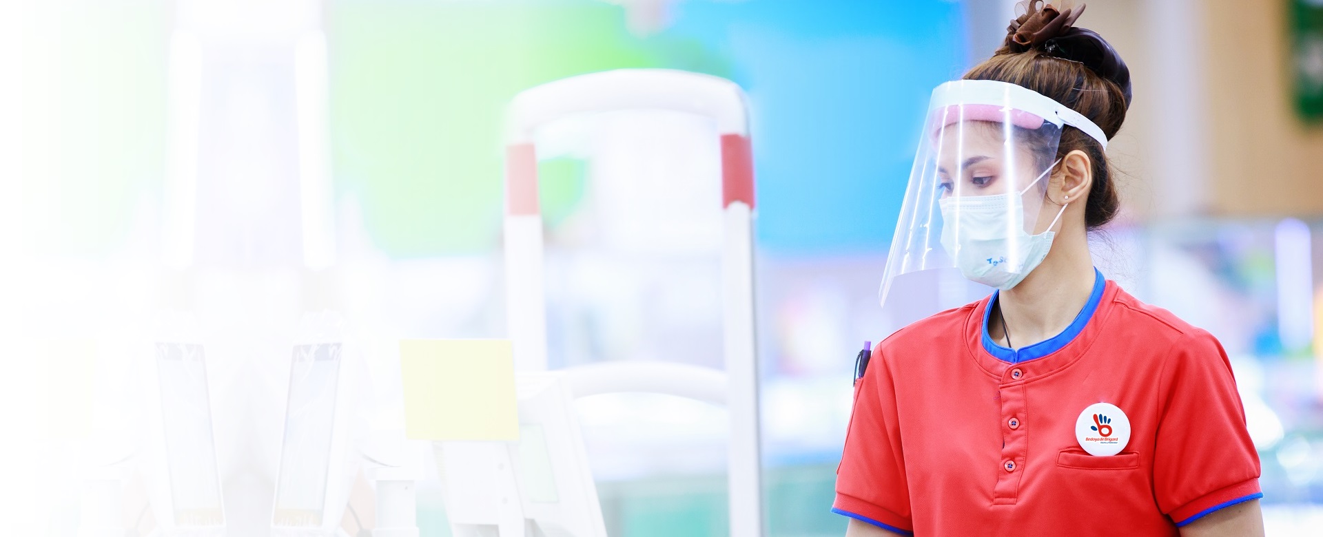 female supermarket cashier in medical protective mask and face s